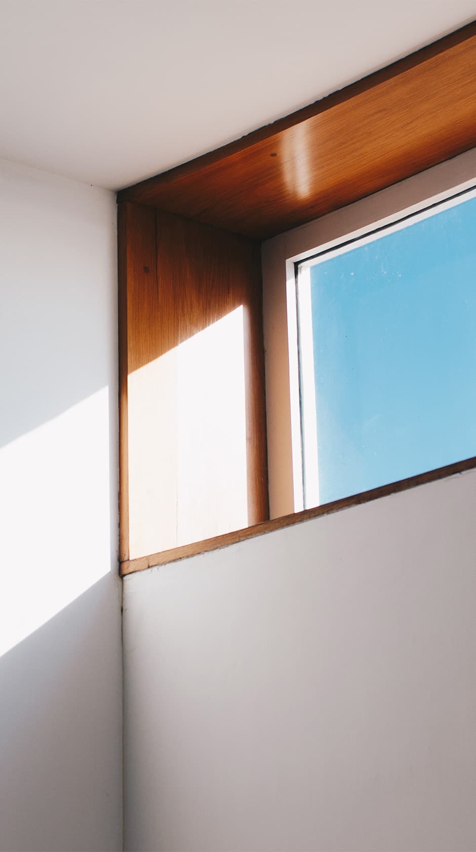 Daylight falling through a wood-framed window